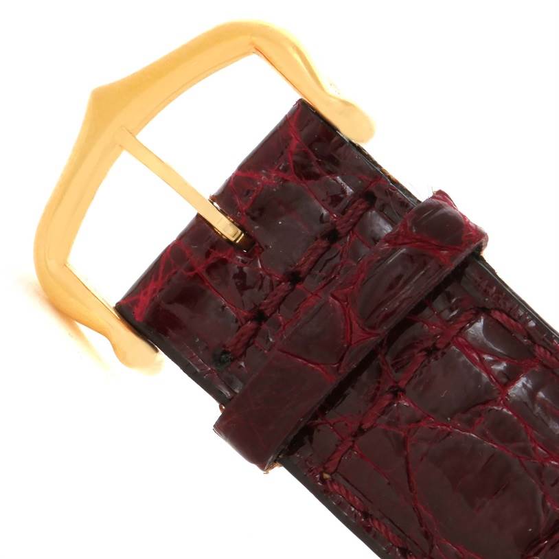 The image shows a close-up of the buckle and strap of a Cartier Tank Louis W1529756 Men's Yellow Gold Silver Dial W1529756 Men's Yellow Gold Silver Dial watch at an angle.