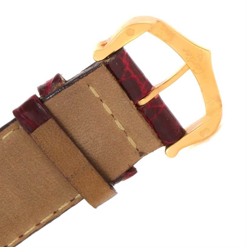 This image shows a close-up of the leather strap and gold buckle of a Cartier Tank Louis W1529756 Men's Yellow Gold Silver Dial W1529756 Men's Yellow Gold Silver Dial watch.