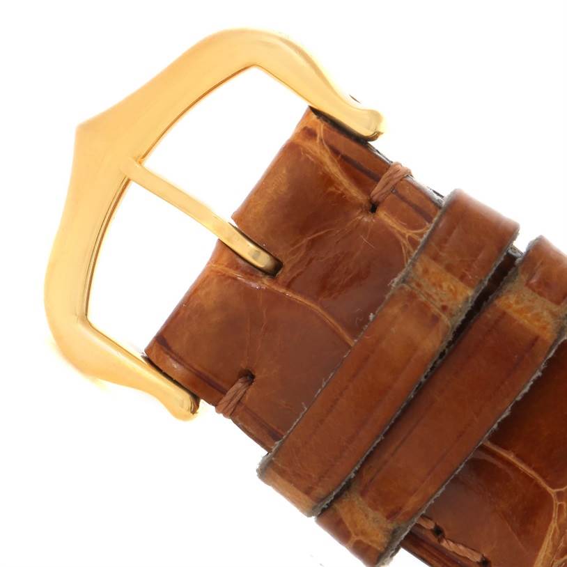 The image shows a close-up of the leather strap and gold buckle of the Cartier Tank Louis W1529756 Yellow Gold Silver Dial W1529756 Yellow Gold Silver Dial model watch.