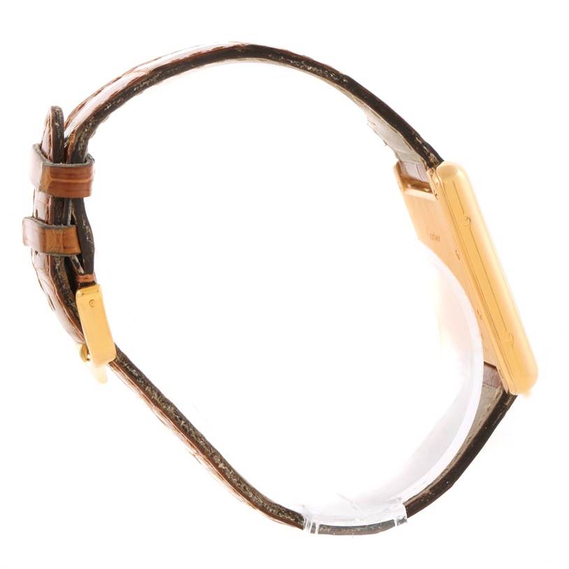 The image shows a Cartier Tank Louis W1529756 Yellow Gold Silver Dial W1529756 Yellow Gold Silver Dial watch in a side profile, displaying the leather strap, gold case, and buckle.