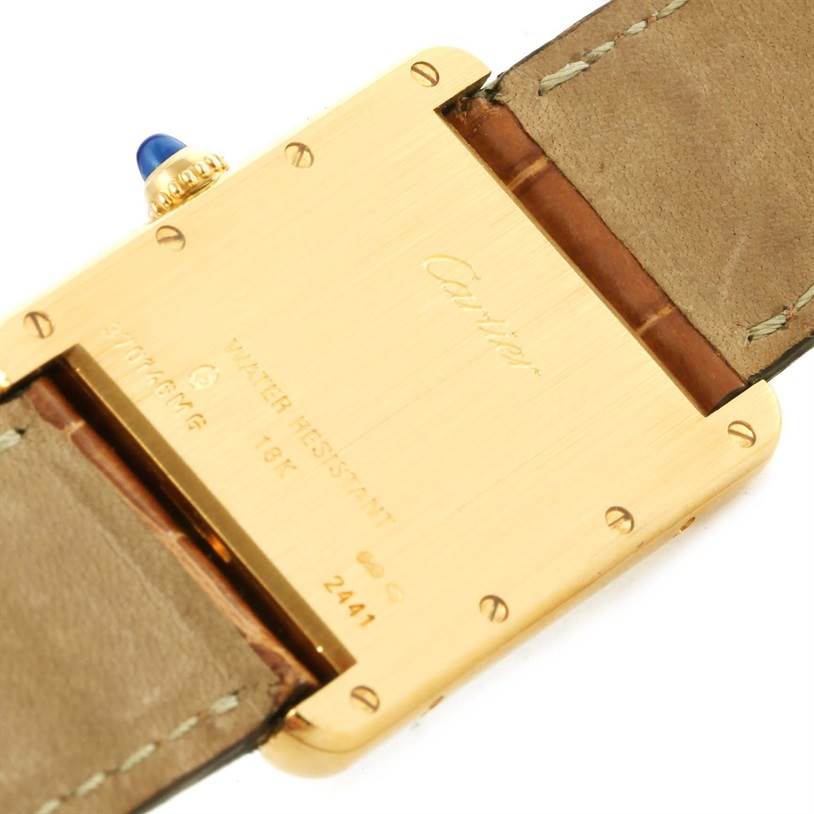 This image shows the back case and strap of a Cartier Tank Louis W1529756 Men's Yellow Gold Silver Dial W1529756 Men's Yellow Gold Silver Dial watch, highlighting the inscriptions and the crown with a blue cabochon.