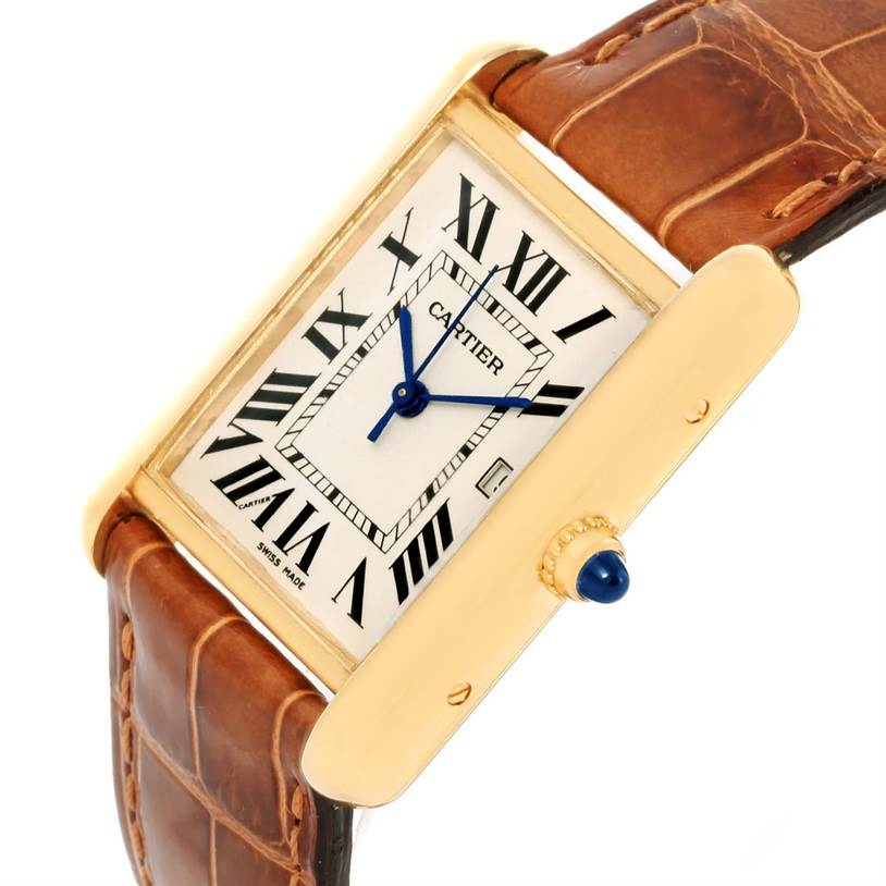 The image shows a Cartier Tank Louis W1529756 Men's Yellow Gold Silver Dial W1529756 Men's Yellow Gold Silver Dial watch at an angle highlighting the face, leather strap, and crown with a blue cabochon.