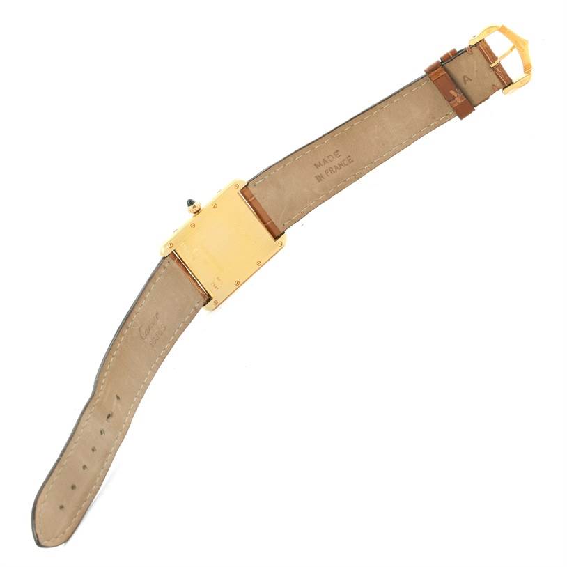 The image shows the back of the Tank Louis watch by Cartier, including its straps, buckle, and case back.