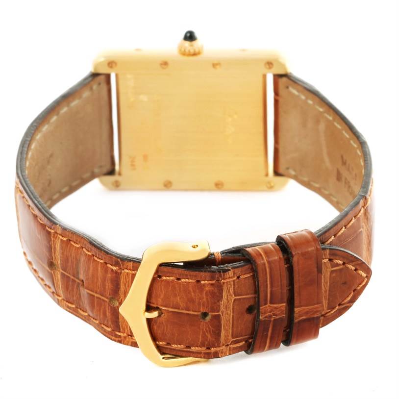 This image shows the back view of a Cartier Tank Louis W1529756 Men's Yellow Gold Silver Dial W1529756 Men's Yellow Gold Silver Dial watch, highlighting its leather strap and gold buckle.