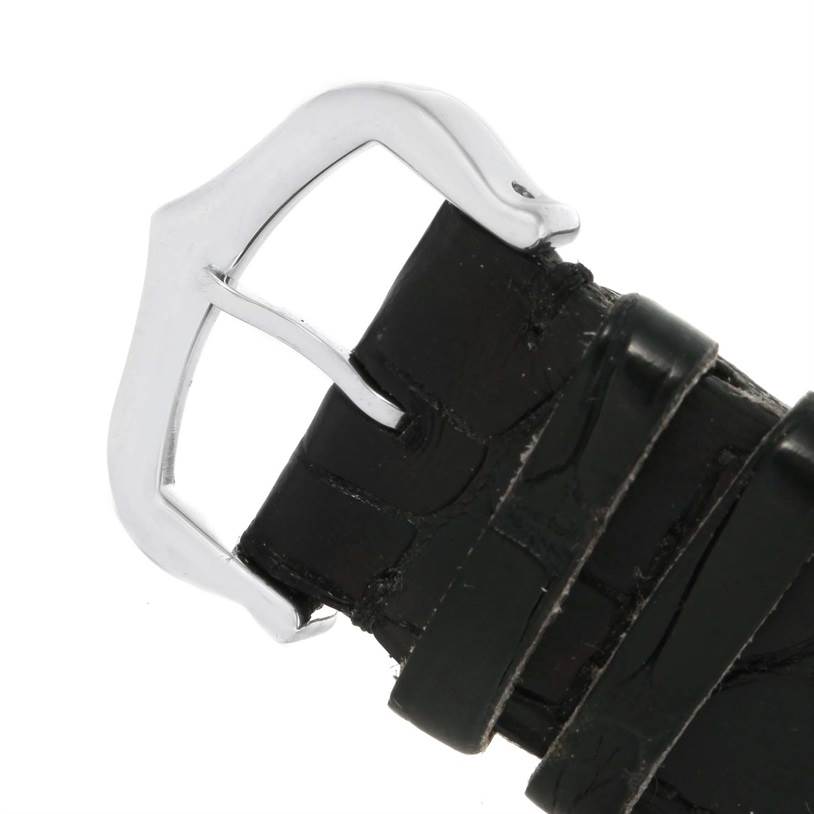 The image shows a close-up of the buckle and strap of a Tank Louis model by Cartier.