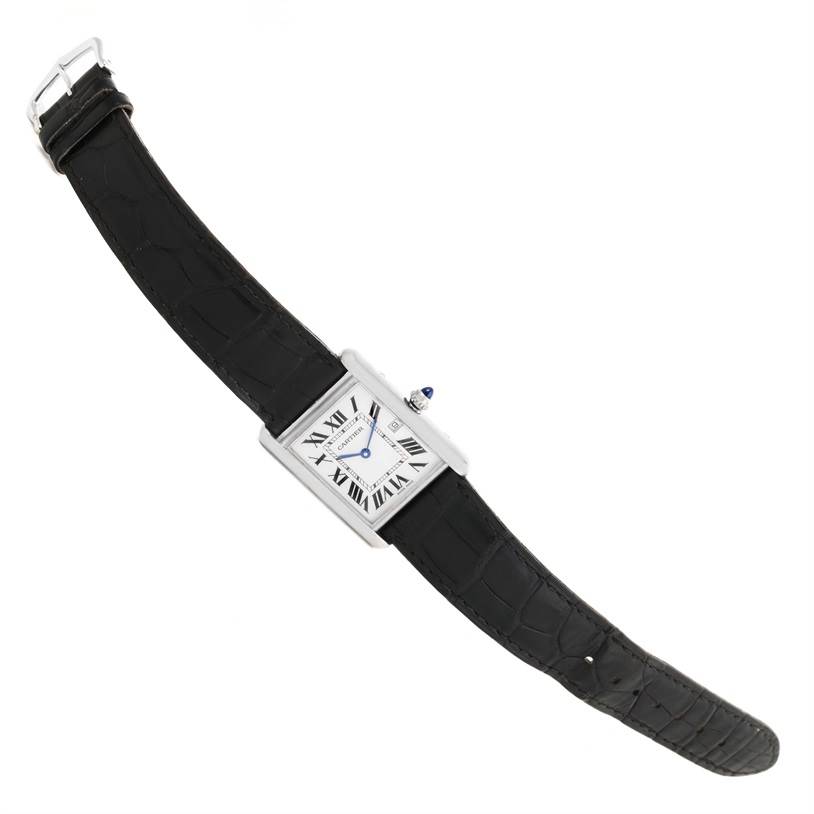 The Cartier Tank Louis W1540956 White Gold Silver Dial W1540956 White Gold Silver Dial watch is shown from a top-down angle, displaying its black leather strap and rectangular face with Roman numerals.