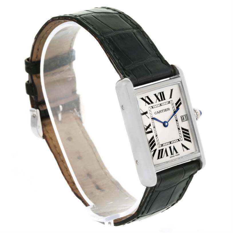 The image shows a Tank Louis watch by Cartier at an oblique angle, displaying the black leather strap, rectangular dial, and side view of the case.
