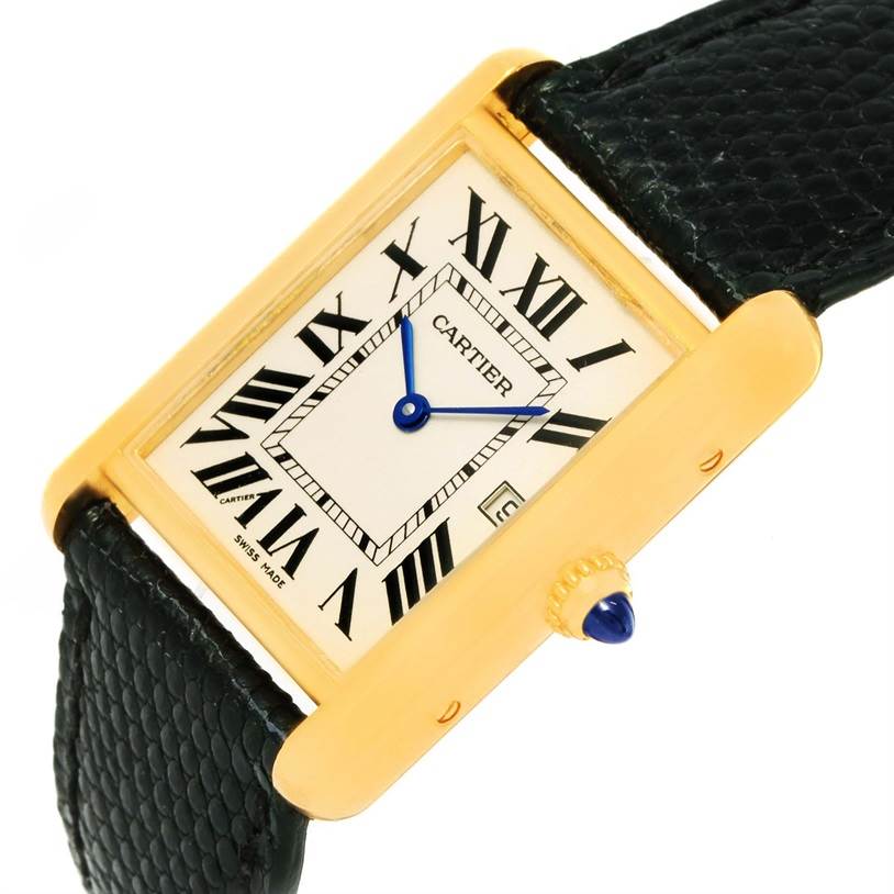 The image shows a Tank Louis watch by Cartier at a slight angle, highlighting its gold case, Roman numeral dial, blue hands, and black strap.