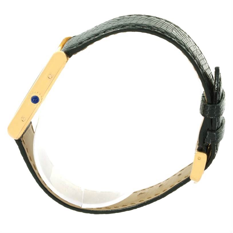 The image shows a side view of the Cartier Tank Louis W1529756 Men's Yellow Gold Silver Dial W1529756 Men's Yellow Gold Silver Dial watch, highlighting its strap and crown.