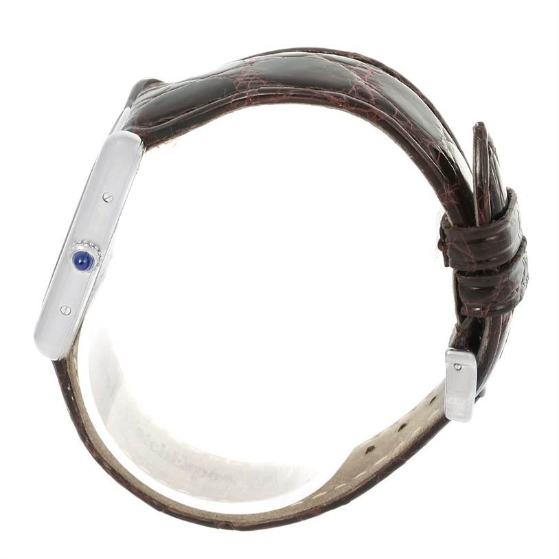 The image shows a side view of a Cartier Tank Louis W1540956 Men's White Gold Silver Dial W1540956 Men's White Gold Silver Dial watch, highlighting its leather strap and crown with a blue cabochon.