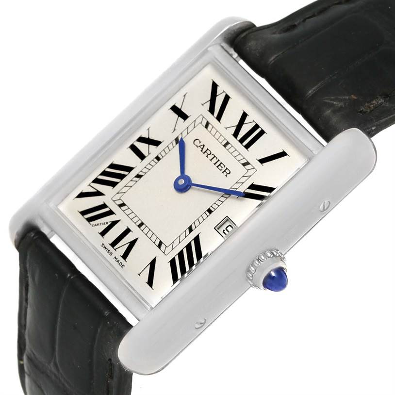 The Tank Louis watch by Cartier is shown at an angled view, highlighting the face, Roman numerals, and side crown.
