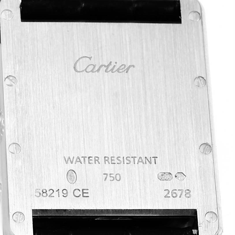 This image shows the back case of a Tank Louis model watch by Cartier, displaying engravings and screws.