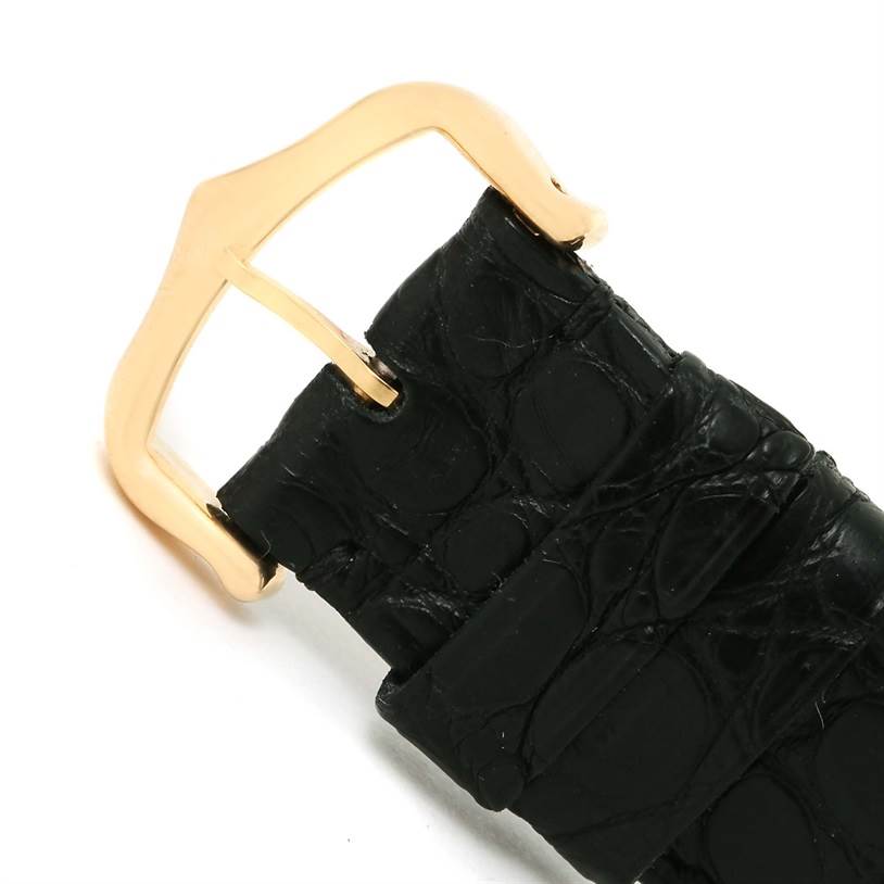 This image shows a close-up of the buckle and strap of a Tank Louis model watch by Cartier.