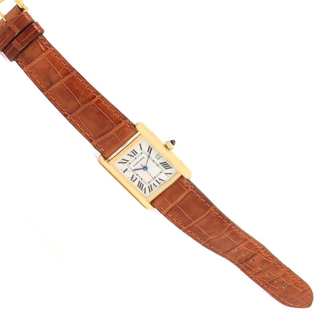 The image shows a top view of a Cartier Tank Louis W1529756 Men
s Yellow Gold Silver Dial W1529756 Men
s Yellow Gold Silver Dial watch, highlighting its rectangular dial, Roman numerals, and brown leather strap.