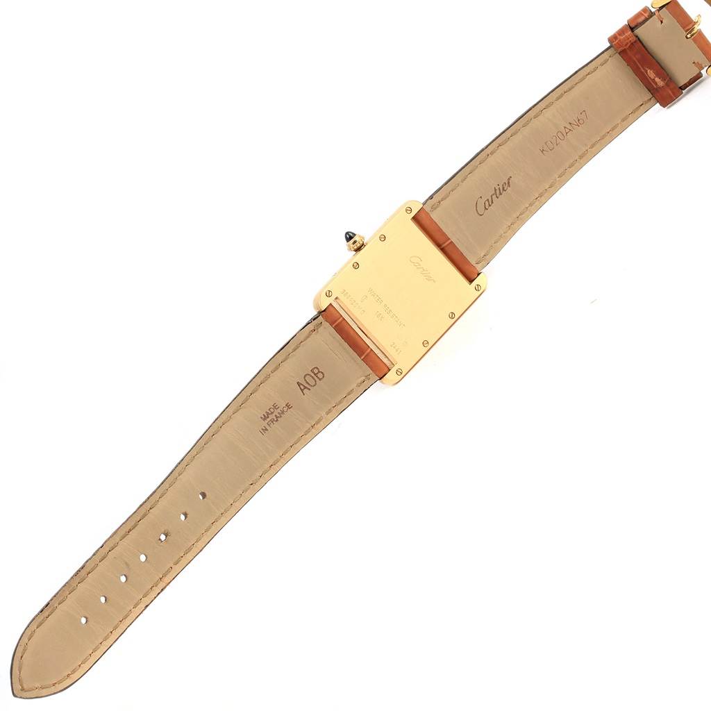 The image shows the back and inside strap of a Cartier Tank Louis W1529756 Men
s Yellow Gold Silver Dial W1529756 Men
s Yellow Gold Silver Dial watch laid flat, highlighting the brand markings and buckle.