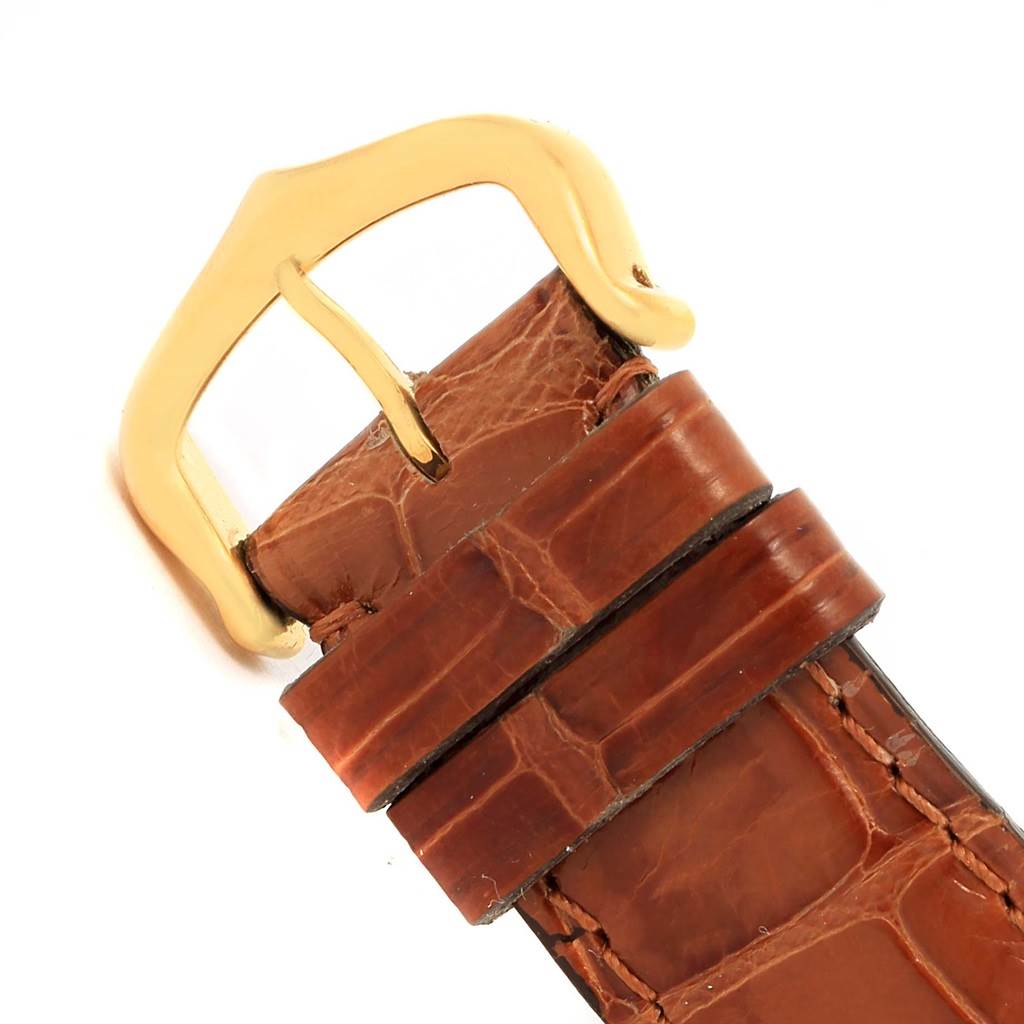The image shows a close-up of the leather strap and gold buckle of a Cartier Tank Louis W1529756 Men
s Yellow Gold Silver Dial W1529756 Men
s Yellow Gold Silver Dial watch.