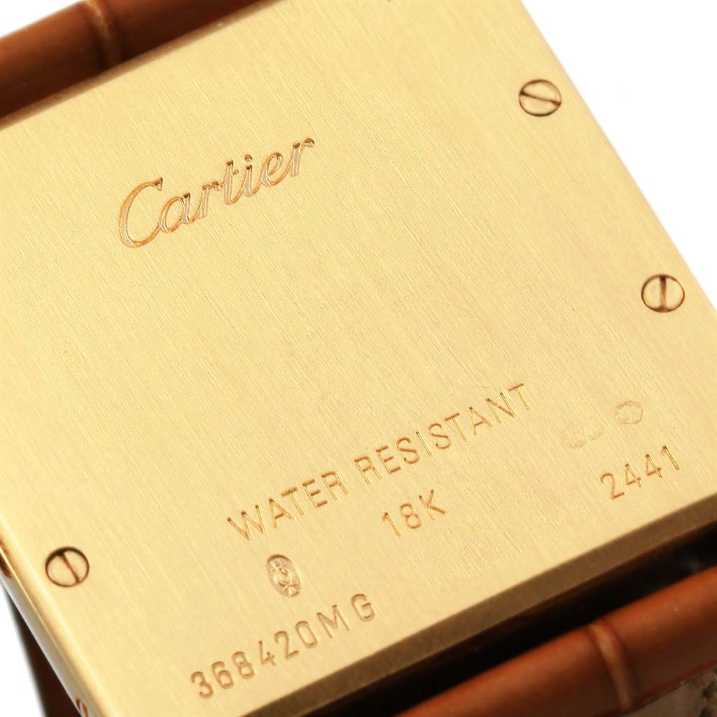 This image shows the back case of a Cartier Tank Louis W1529756 Men
s Yellow Gold Silver Dial W1529756 Men
s Yellow Gold Silver Dial watch with inscriptions and screw details.