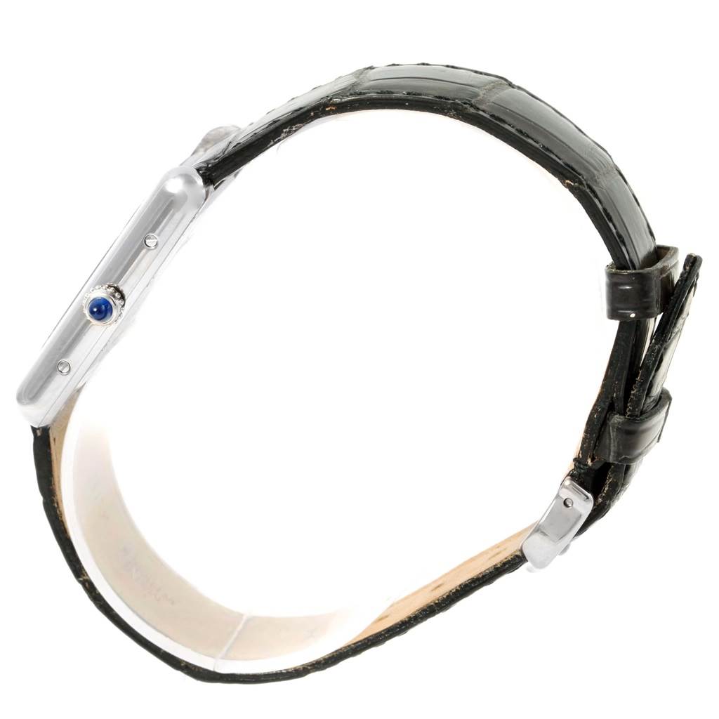 The Tank Louis Cartier watch is shown from the side, displaying its strap, case profile, and crown.