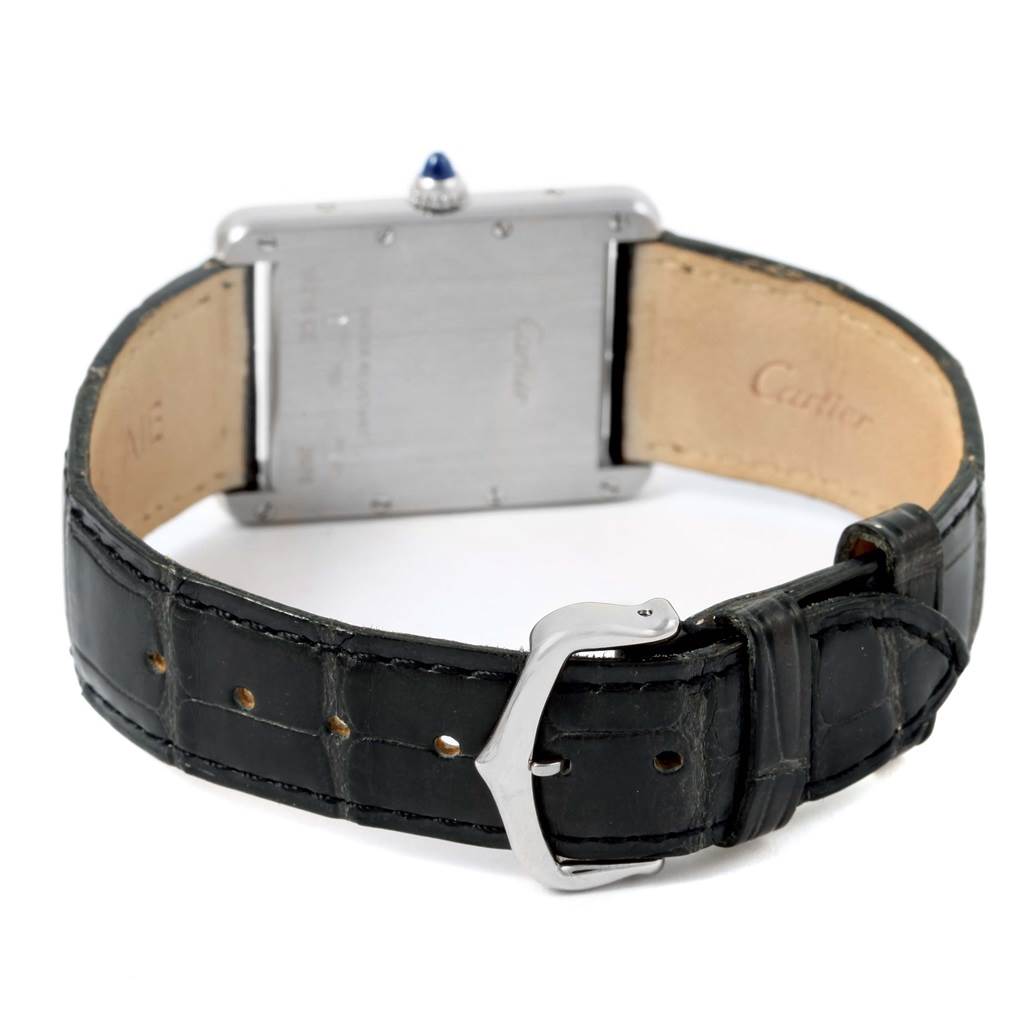 The image shows the back view of a Tank Louis watch by Cartier, displaying its clasp, strap, and caseback.