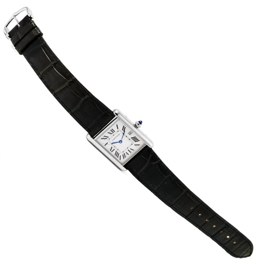 The image shows a Tank Louis model by Cartier from a top view, displaying its rectangular dial, black leather strap, and blue hands.