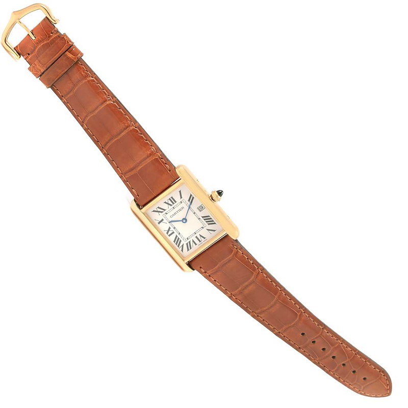 The image shows an overhead view of a Cartier Tank Louis watch, including the face, strap, and buckle.