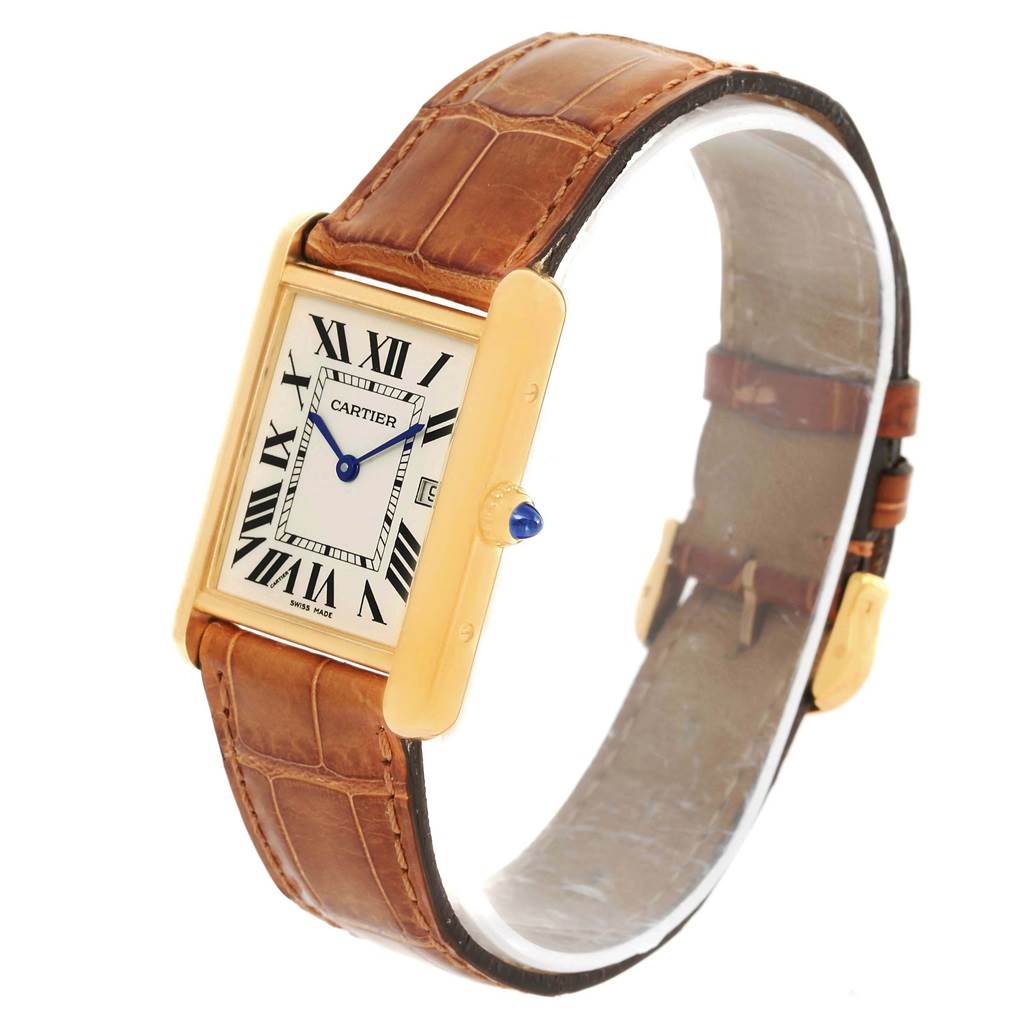 The image shows a Tank Louis watch by Cartier at a slight diagonal angle, highlighting its face, case, crown, and leather strap.