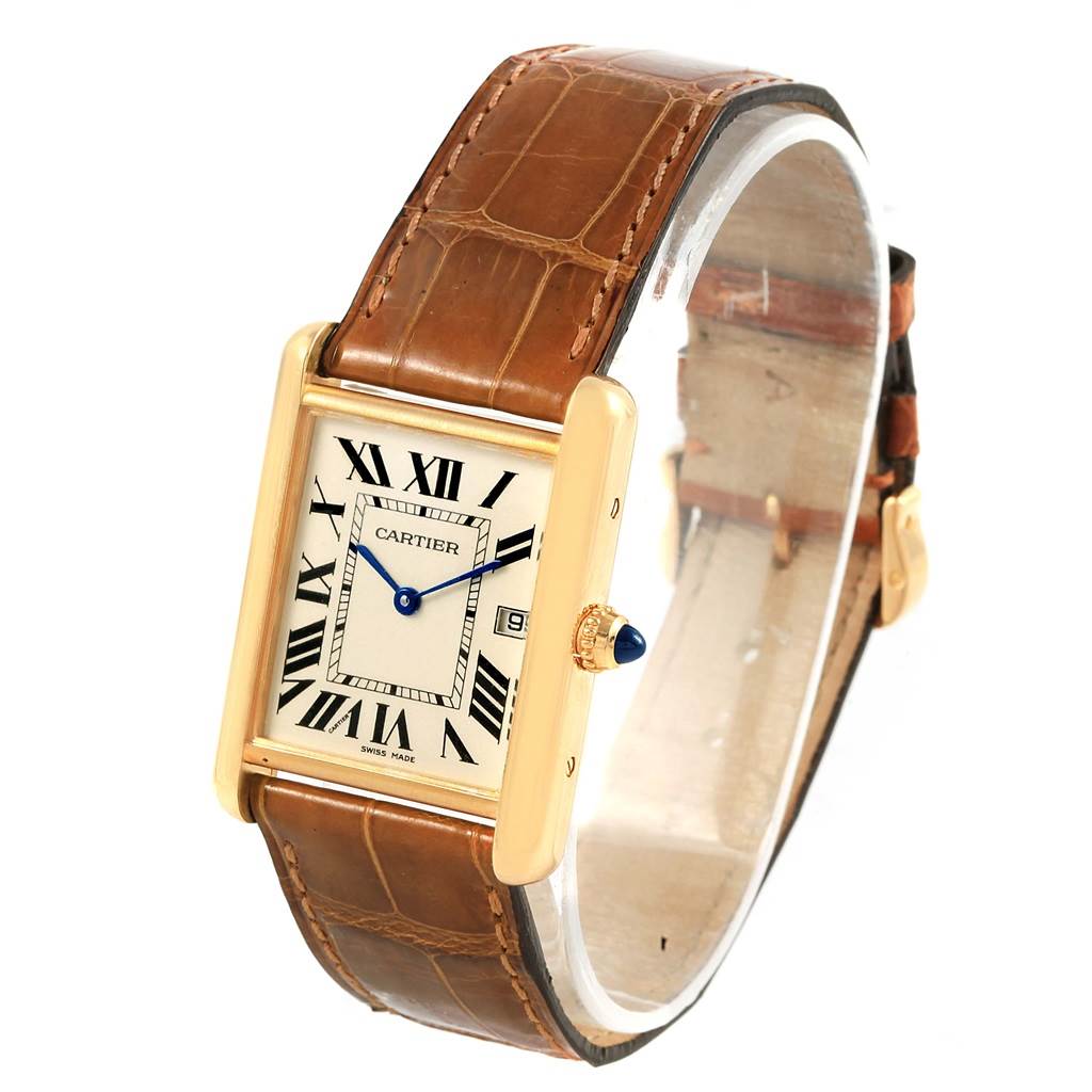 The image shows a Tank Louis watch by Cartier at a slight front angle, showcasing the dial, bezel, crown, and leather strap.