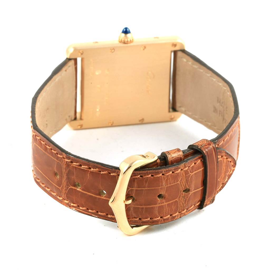 The image shows the back view of a Cartier Tank Louis W1529756 Yellow Gold Silver Dial W1529756 Yellow Gold Silver Dial watch, focusing on the buckle and leather strap.