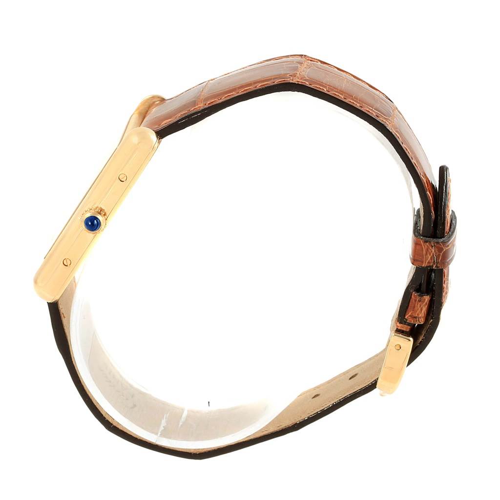 The Cartier Tank Louis W1529756 Yellow Gold Silver Dial W1529756 Yellow Gold Silver Dial watch is shown from a side angle, highlighting its profile and brown leather strap.