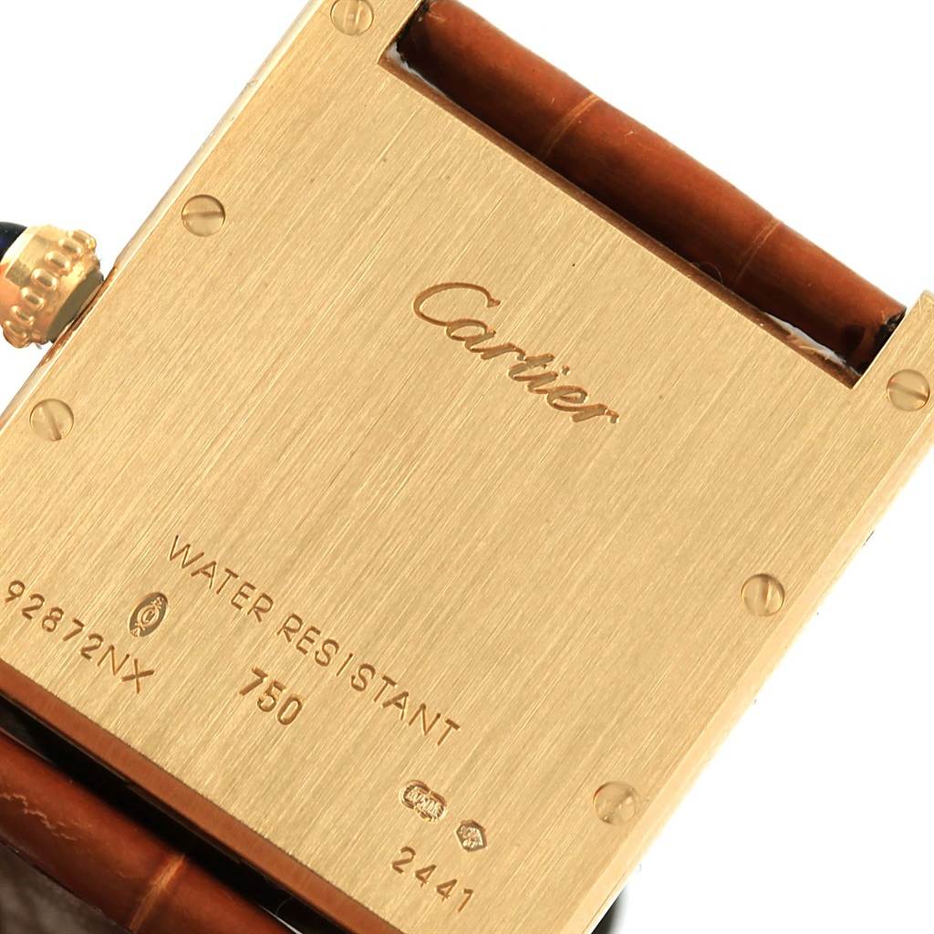 The image shows the back of a Cartier Tank Louis W1529756 Yellow Gold Silver Dial W1529756 Yellow Gold Silver Dial watch, featuring the brand name, model details, and part of the strap.