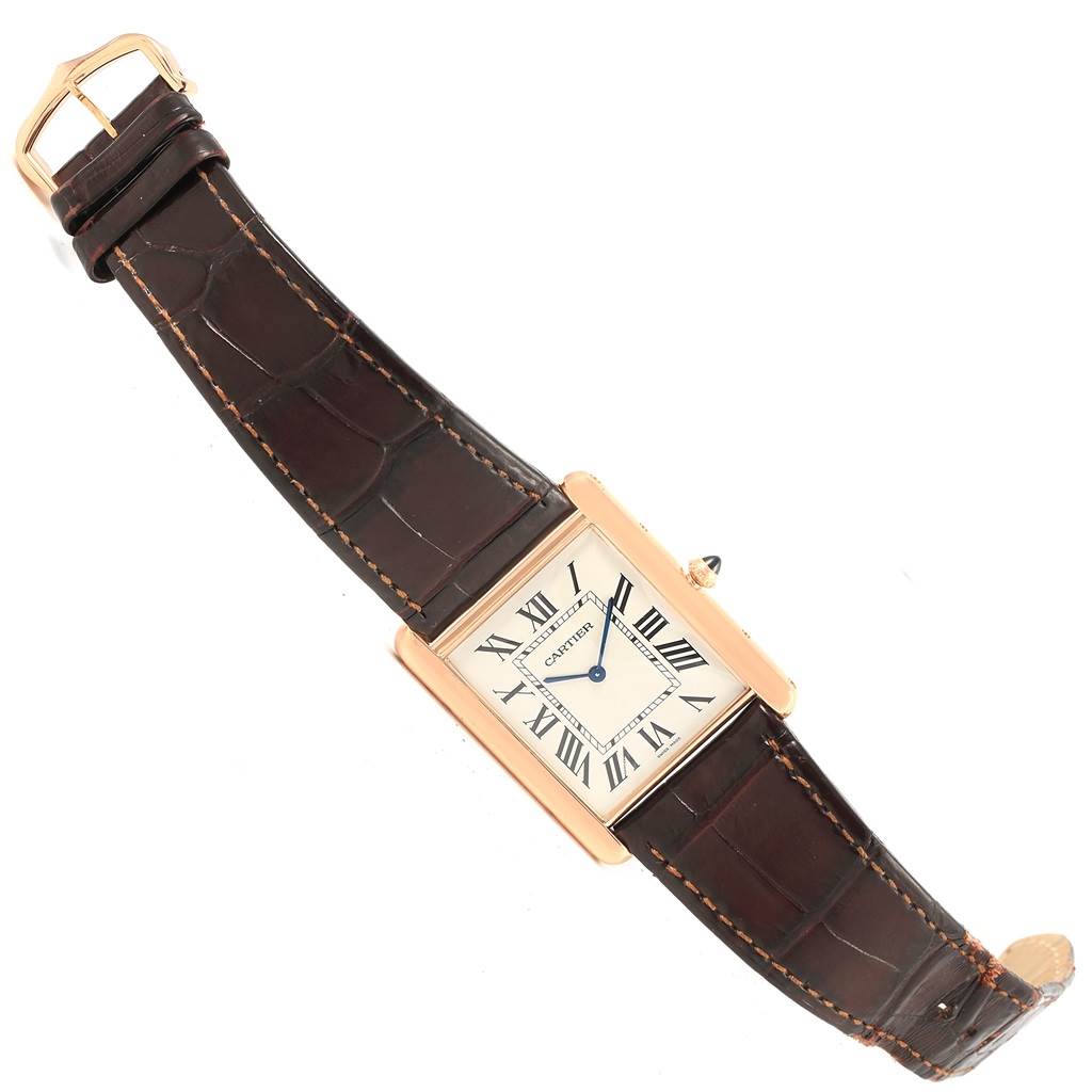 The image shows a Cartier Tank Louis W1560017 Men's Rose Gold Silver Dial W1560017 Men's Rose Gold Silver Dial watch from a top-down angle, displaying its rectangular case, leather strap, and Roman numeral dial.