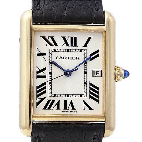 The image shows a frontal view of a Tank Louis watch by Cartier, displaying the face, Roman numerals, and part of the black leather strap.