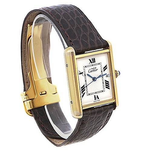 The image shows a side angle of a Cartier Tank Louis Yellow Gold White Dial Yellow Gold White Dial watch, displaying its gold case, brown leather strap, and its face with Roman numerals.