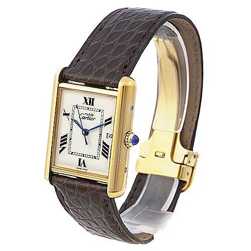 This image shows a Tank Louis watch by Cartier at an oblique angle, highlighting the face, strap, and clasp.