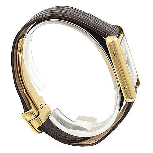 A side view of a Cartier Tank Louis Yellow Gold White Dial Yellow Gold White Dial watch showcases its brown leather strap and gold case.