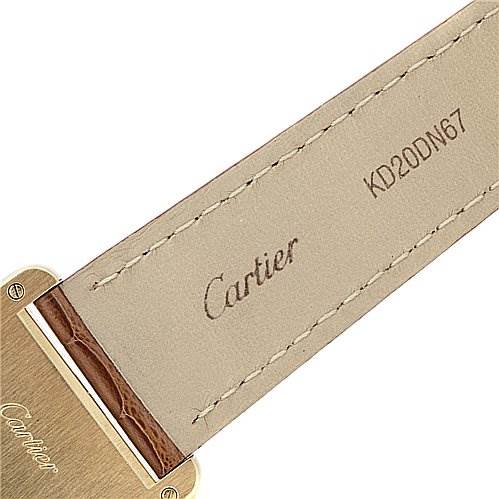 The image shows the back side of the strap and part of the case of a Cartier Tank Louis W1529756 Yellow Gold White Dial W1529756 Yellow Gold White Dial watch with the Cartier logo and a serial number.