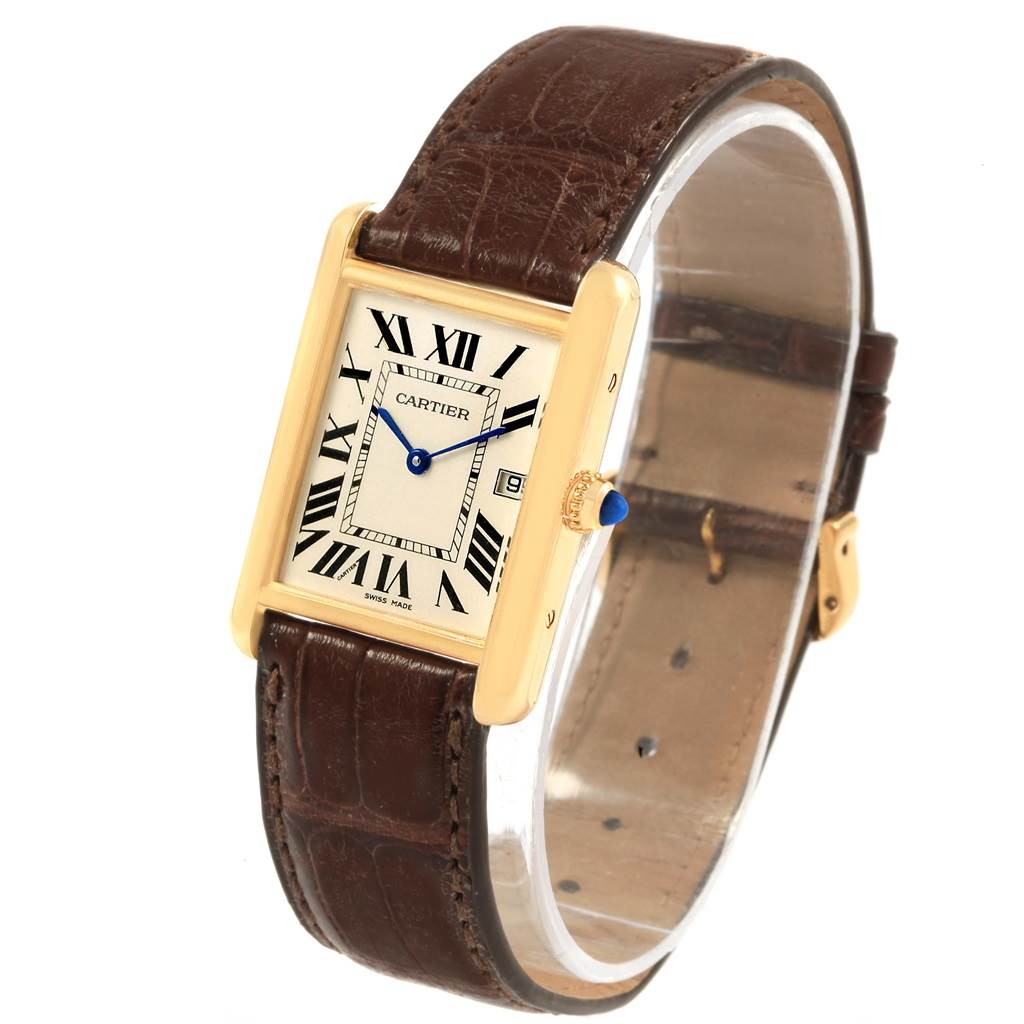 The Tank Louis Cartier watch is shown from an angled side view, highlighting its rectangular face, brown leather strap, and gold casing.