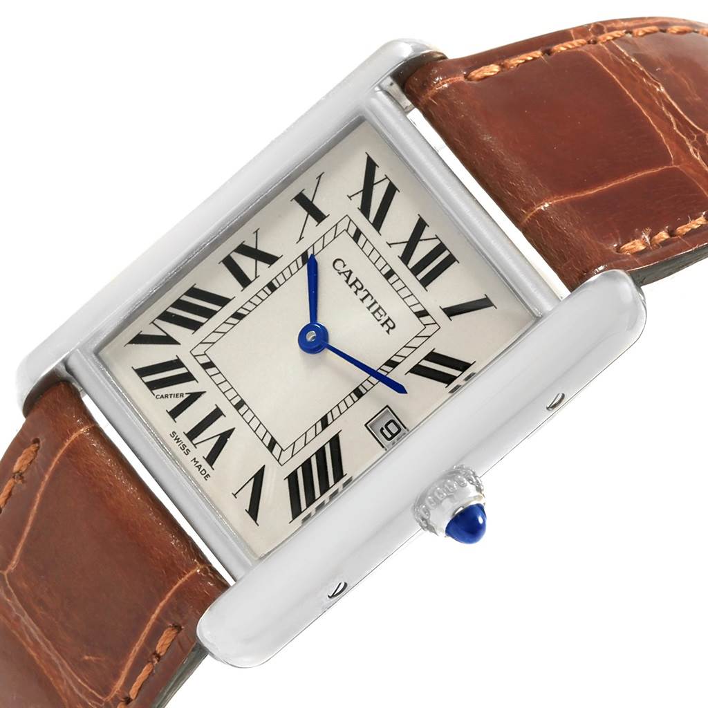 This image displays a close-up angled view of the Tank Louis Cartier watch face and crown, showing its brown leather strap.