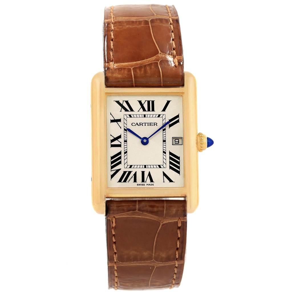 The image shows a Tank Louis watch by Cartier, featuring its rectangular face, Roman numerals, and brown leather strap from a top-down angle.
