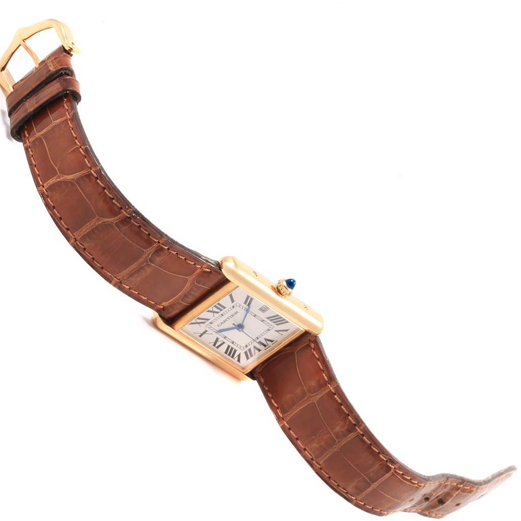 The image shows a Cartier Tank Louis W1529756 Men
s Yellow Gold Silver Dial W1529756 Men
s Yellow Gold Silver Dial watch at an angle, highlighting its face, crown, and brown leather strap.