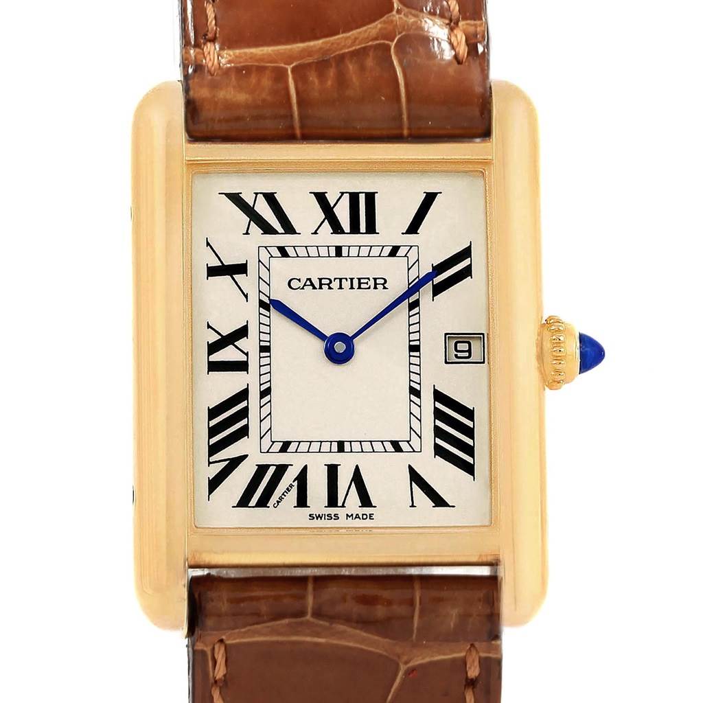 The image shows the Cartier Tank Louis W1529756 Men
s Yellow Gold Silver Dial W1529756 Men
s Yellow Gold Silver Dial watch face and part of its leather strap, featuring Roman numerals and a date window.