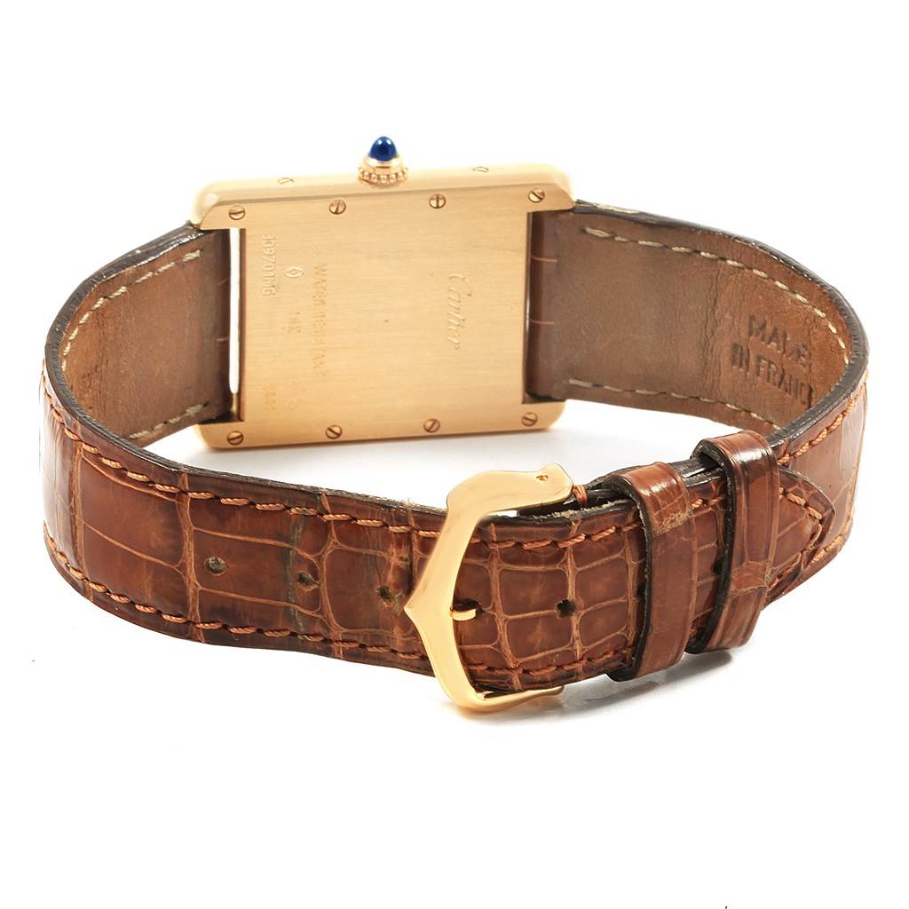The image shows the back view of a Cartier Tank Louis W1529756 Men
s Yellow Gold Silver Dial W1529756 Men
s Yellow Gold Silver Dial watch, highlighting the case back, brown leather strap, and gold buckle.