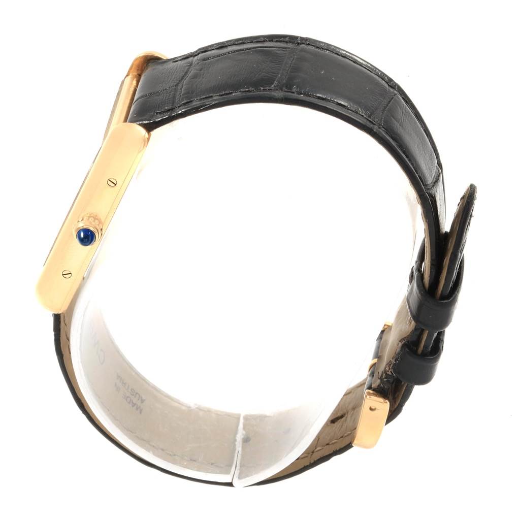 The image shows a side view of the Cartier Tank Louis W1529756 Men's Yellow Gold Silver Dial W1529756 Men's Yellow Gold Silver Dial watch, highlighting its gold case, crown, and black leather strap.