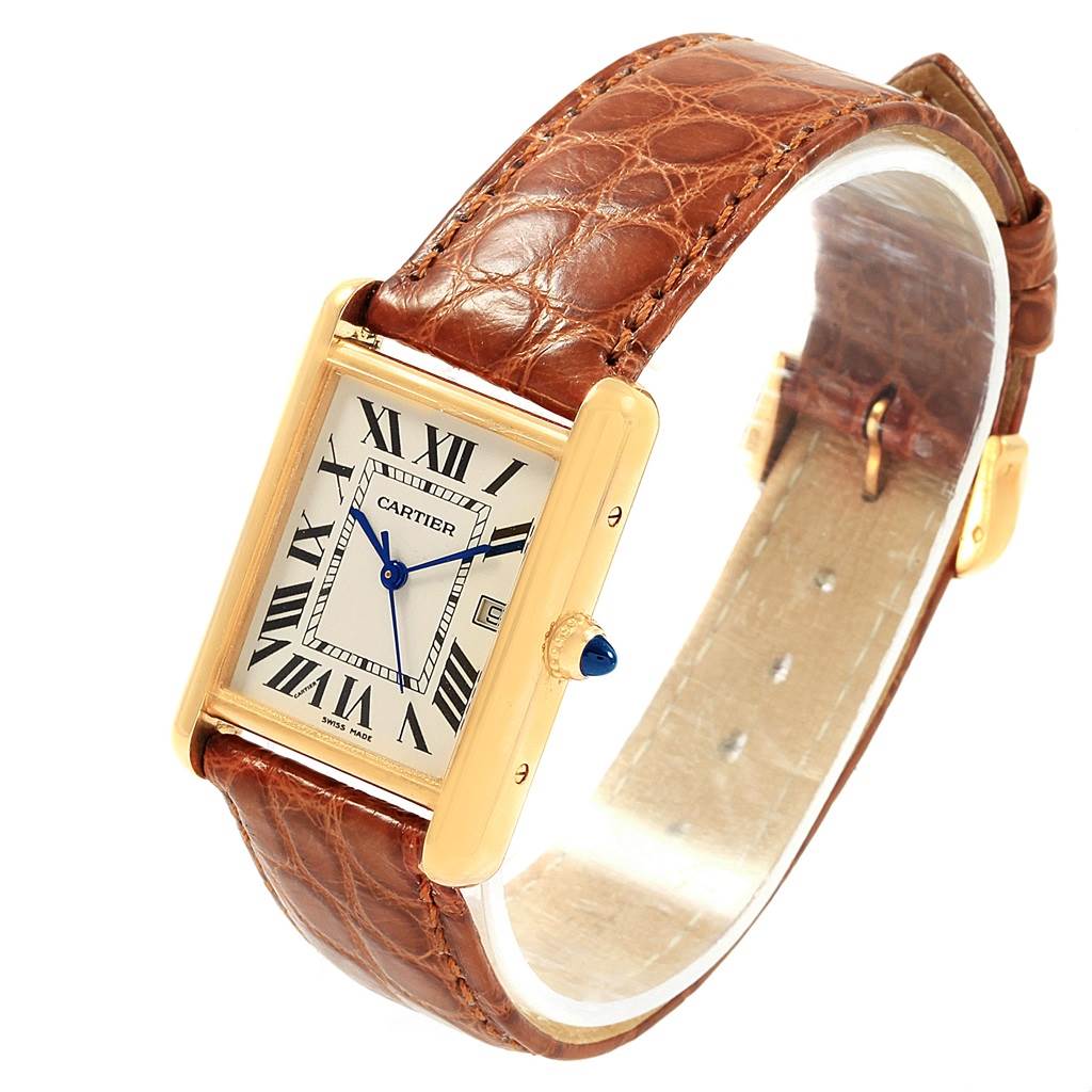 The Cartier Tank Louis W1529756 Men
s Yellow Gold Silver Dial W1529756 Men
s Yellow Gold Silver Dial watch is shown at a three-quarter angle, highlighting its rectangular case, dial, and leather strap.