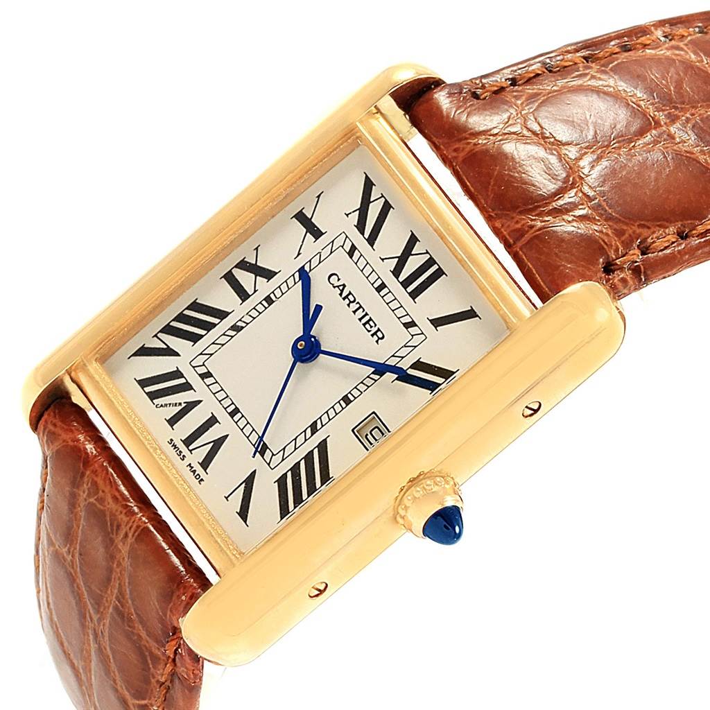 The Cartier Tank Louis W1529756 Men
s Yellow Gold Silver Dial W1529756 Men
s Yellow Gold Silver Dial watch is shown at an angle, highlighting its face, gold casing, and brown leather strap.