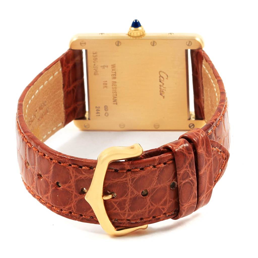 This image shows the back view of a Cartier Tank Louis W1529756 Men
s Yellow Gold Silver Dial W1529756 Men
s Yellow Gold Silver Dial watch, highlighting the gold case, strap, and buckle.