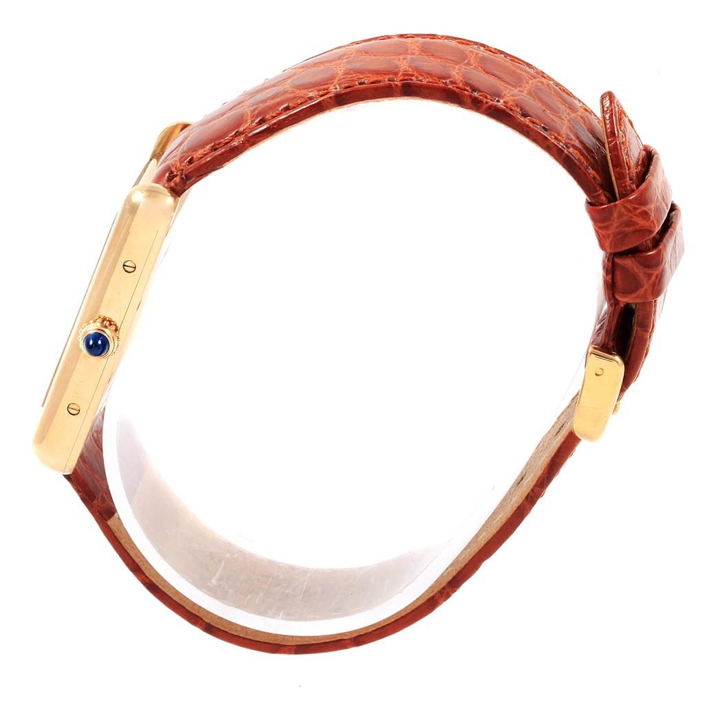 The image shows a side view of a Cartier Tank Louis W1529756 Men
s Yellow Gold Silver Dial W1529756 Men
s Yellow Gold Silver Dial watch, highlighting the crown and brown leather strap.