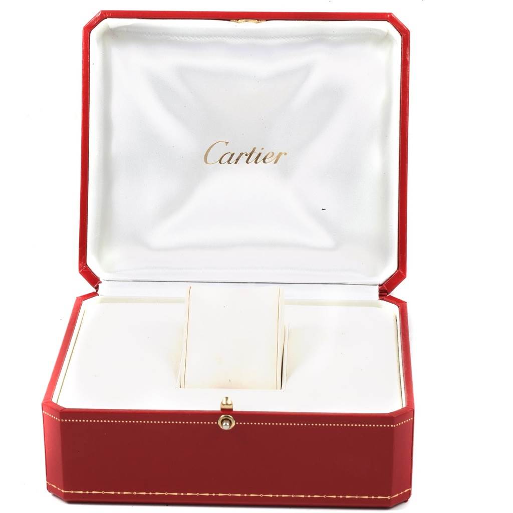 This image shows an open red Cartier watch box for the Tank Louis model, displaying the interior compartments.