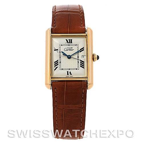 The image shows a frontal view of the Tank Louis model watch by Cartier, highlighting its rectangular face and brown leather strap.