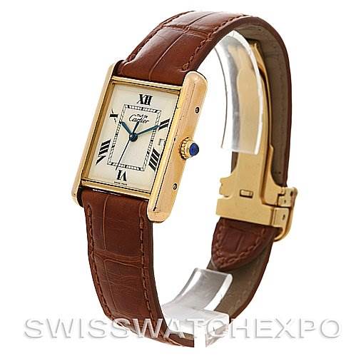 The image shows a side angle of the Cartier Tank Louis Yellow Gold Beige Dial Yellow Gold Beige Dial watch, displaying its rectangular dial and brown leather strap with a deployant clasp.